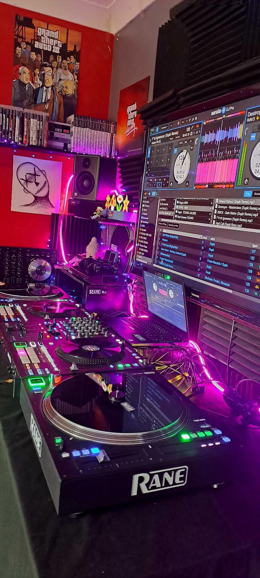 Professional DJ setup with turntables, mixing console, and computer monitors