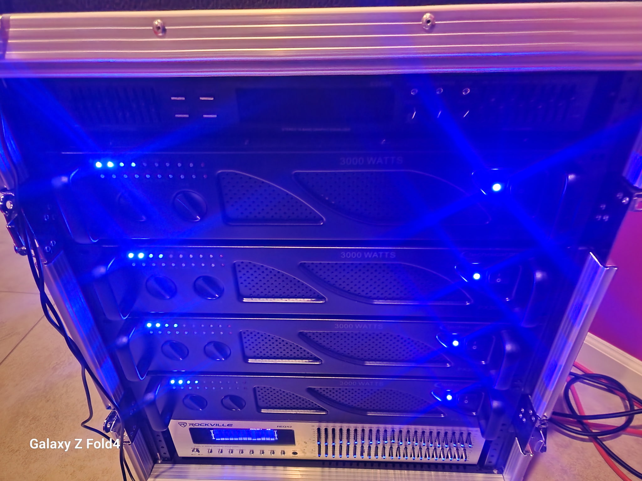 Professional audio rack equipment with amplifiers and LED lighting