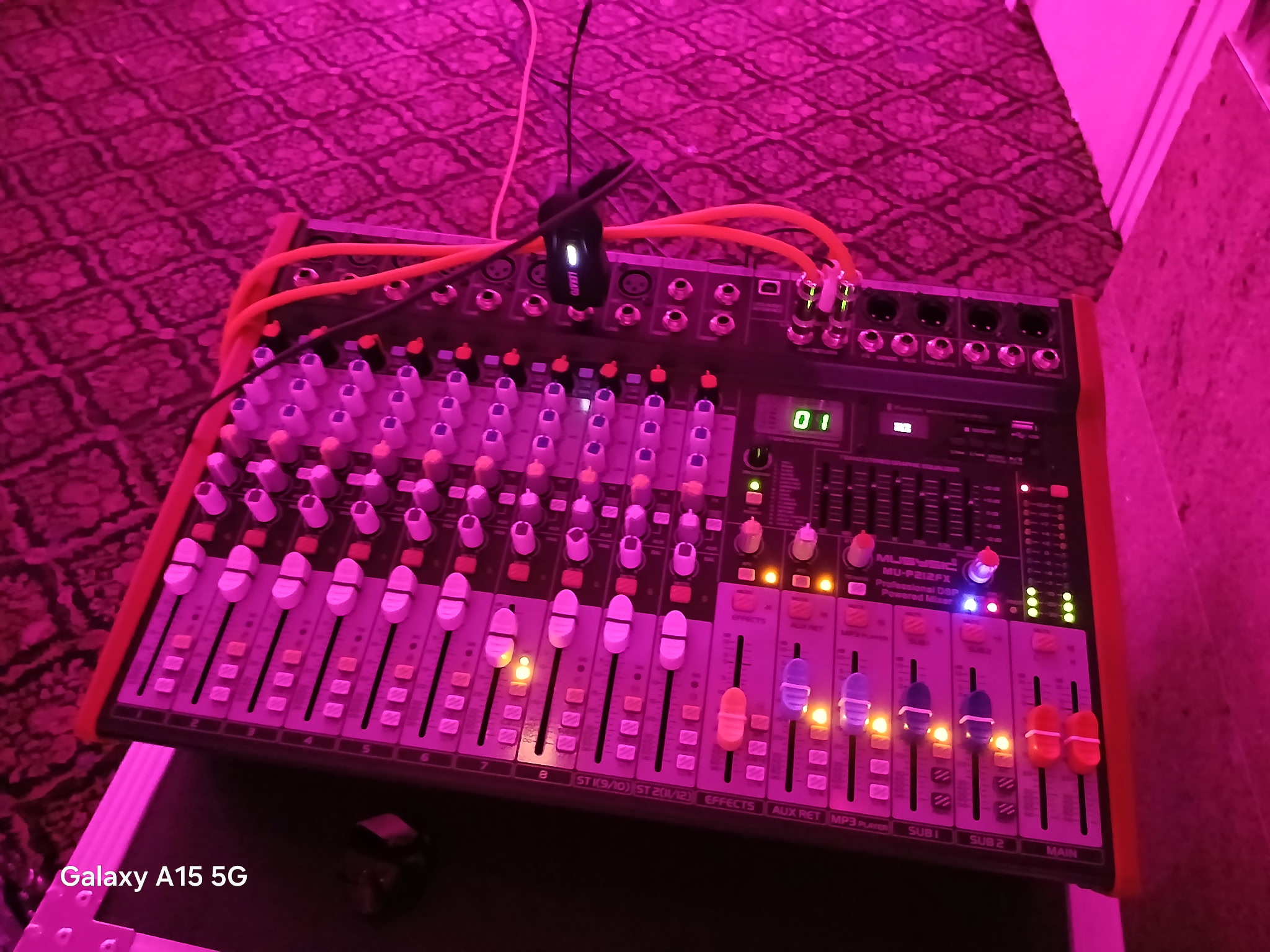 Professional audio mixing console with illuminated controls and faders